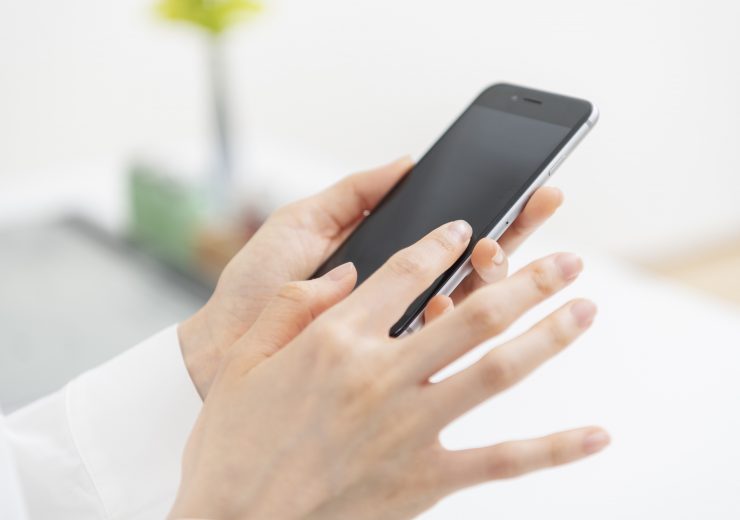 スマートフォンを操作する女性の手元